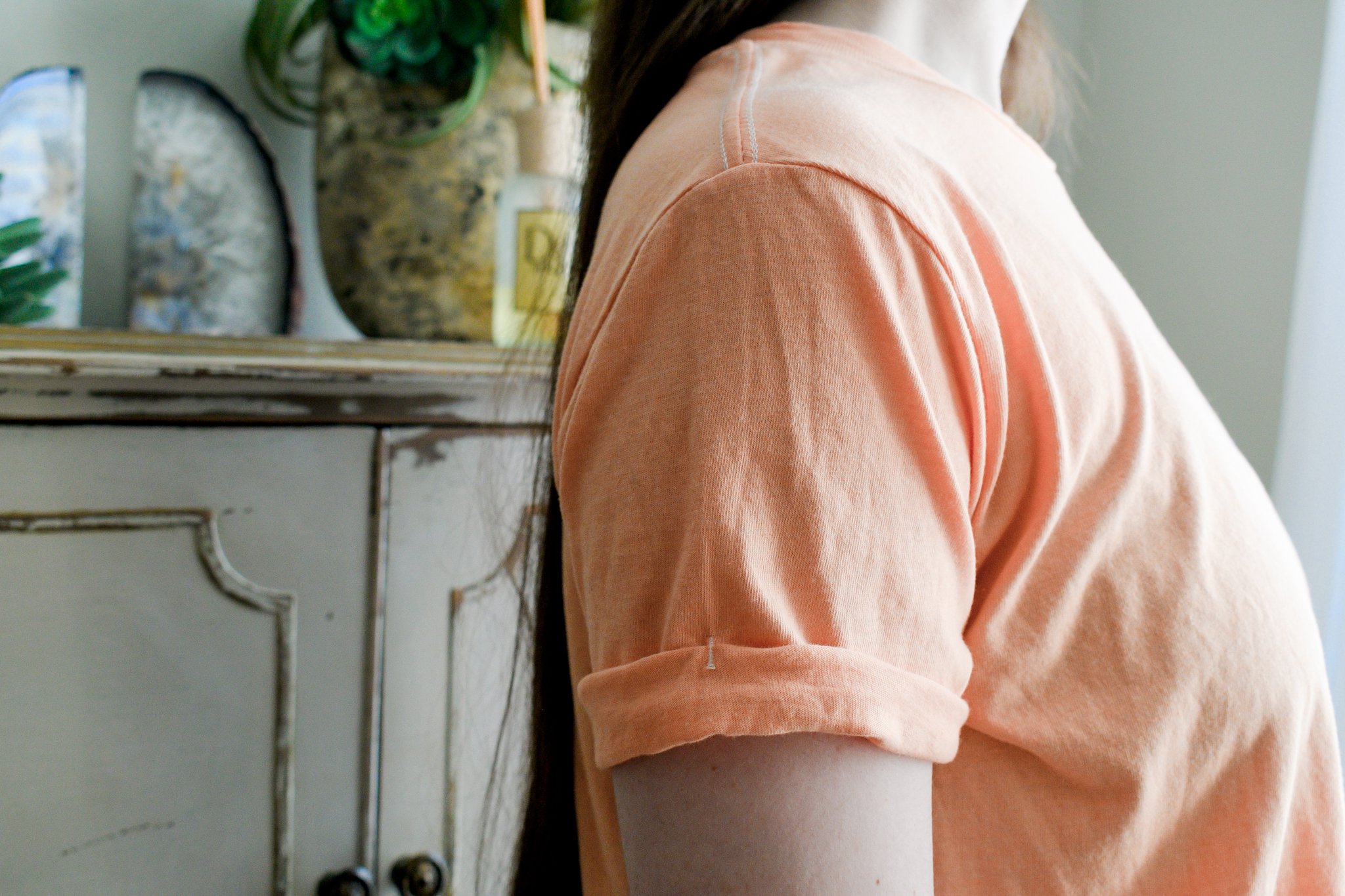 Close up of the cuff on the tultex cropped t-shirt in orange 