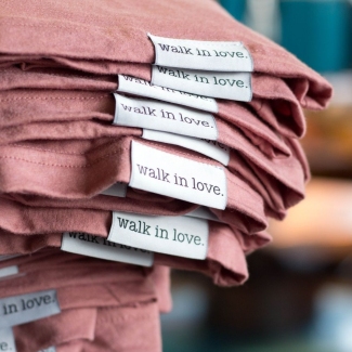 Walk in love custom woven label stack of t-shirts to show off custom labels