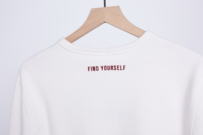 'Find Yourself' embroidered on a white sweatshirt 